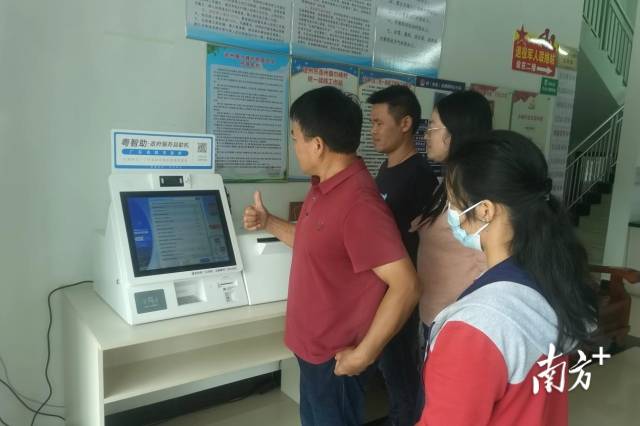 村民老張豎起大拇指點贊“粵智助”政府服務自助機。通訊員供圖