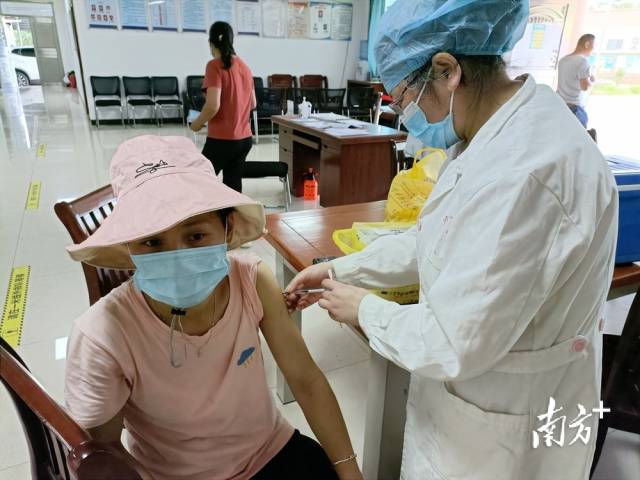 醫(yī)護(hù)人員為村民接種疫苗。